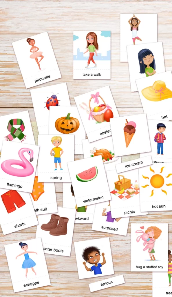 EDITABLE and PRINTABLE-3 part MONTESSORI-FLASHCARDS for kids, with hand drawn illustrations by ANIMAD - image shows top down view of many flashcards on a table, with illustrations of children doing ballet, yoga and objects like watermelon, hot sun, pumpkin, flamingo and more